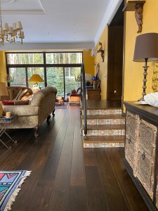 Villa with underfloor heating and black oak flooring.