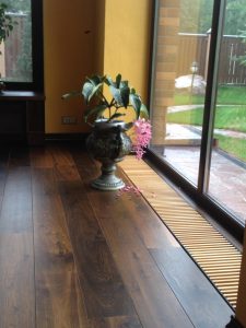 Villa with underfloor heating and black oak flooring.