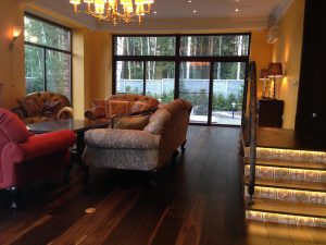 Villa with underfloor heating and black oak flooring.